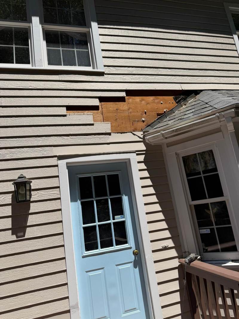 A blue exterior door and painted siding photographed on site.